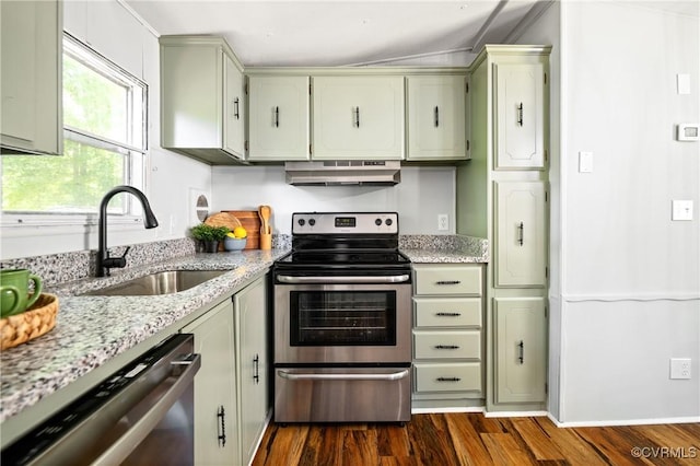 kitchen with stainless steel appliances, a sink, under cabinet range hood, dark wood-type flooring, and light stone countertops