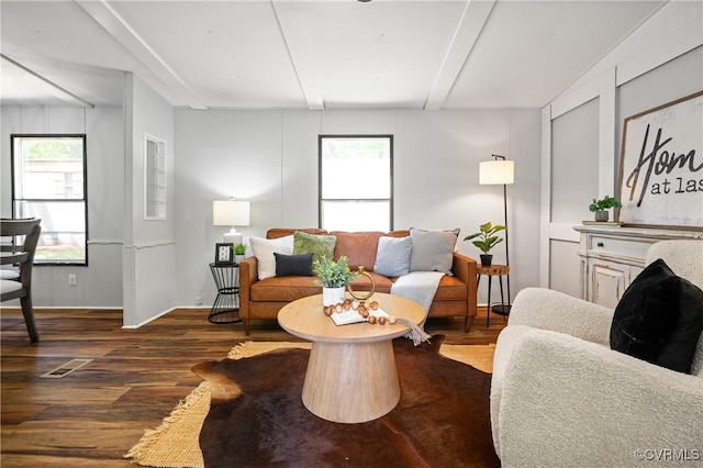 living area featuring wood finished floors and beamed ceiling