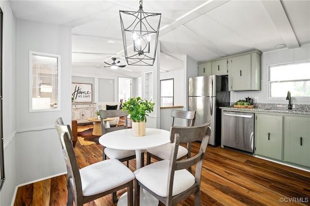 dining area featuring dark wood finished floors, lofted ceiling, and a ceiling fan