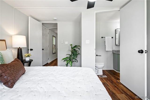 bedroom featuring dark wood-type flooring, ensuite bathroom, and ceiling fan