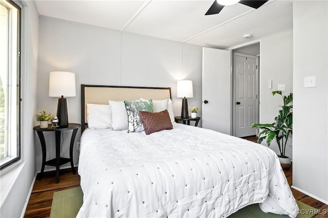 bedroom with wood finished floors, ceiling fan, and baseboards