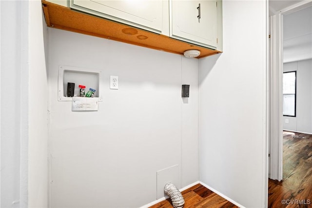 washroom with cabinet space, dark wood-style floors, hookup for a washing machine, and baseboards