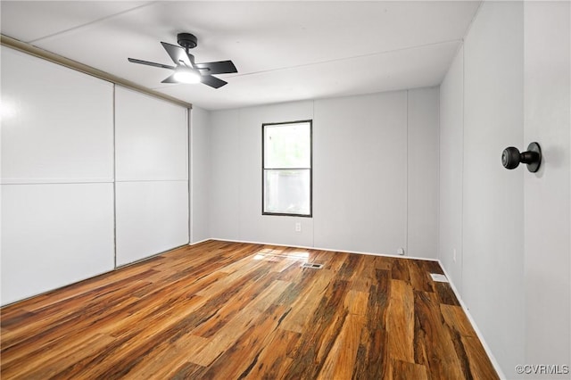 unfurnished room featuring wood finished floors and a ceiling fan