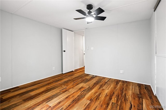 empty room with wood finished floors and a ceiling fan