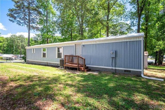 view of front of house with a front yard, central air condition unit, and crawl space