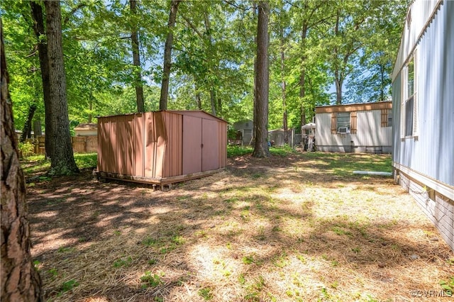 fenced backyard featuring a storage shed and an outdoor structure