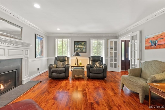 17475 Millfield Ln, Hanover, VA 23192 - living area with a warm lit fireplace, wood finished floors, crown molding, recessed lighting, and french doors