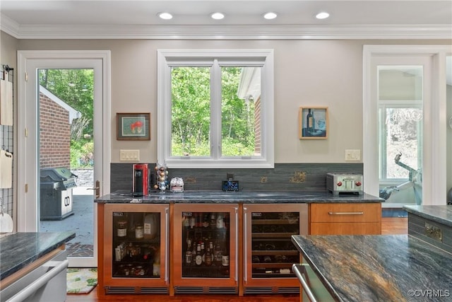 17475 Millfield Ln, Hanover, VA 23192 - kitchen featuring beverage cooler, dark stone countertops, tasteful backsplash, crown molding, and brown cabinetry