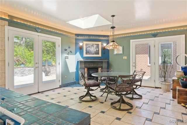 17475 Millfield Ln, Hanover, VA 23192 - dining area with french doors, a skylight, a fireplace, and ornamental molding