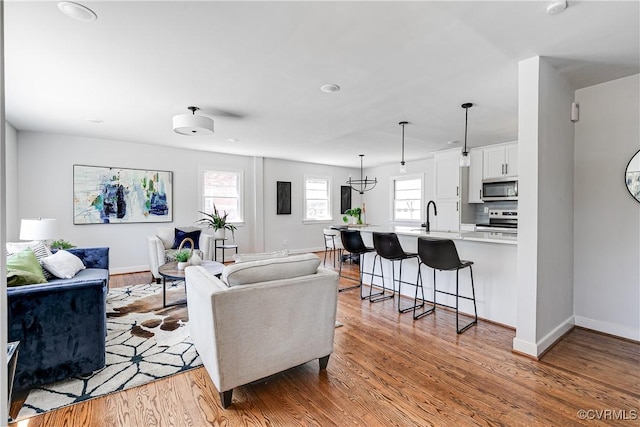 living room featuring light wood-style flooring and baseboards