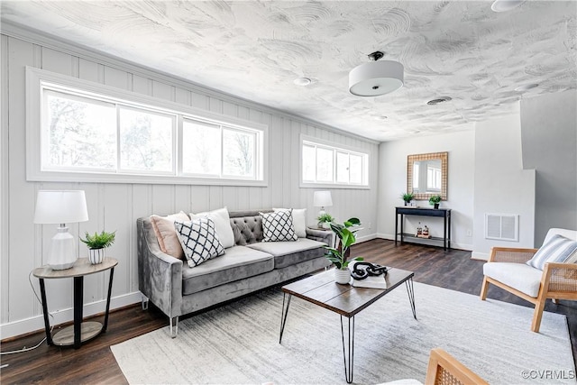 living room featuring baseboards and dark wood finished floors