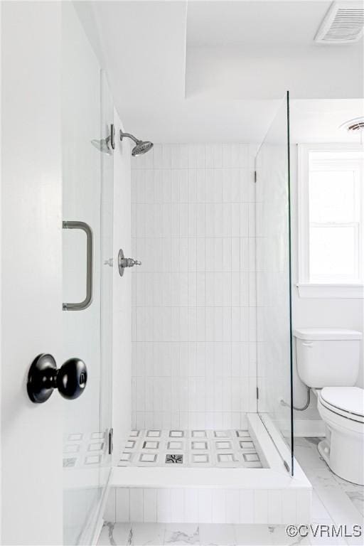 full bath featuring marble look tiles, toilet, and a shower stall
