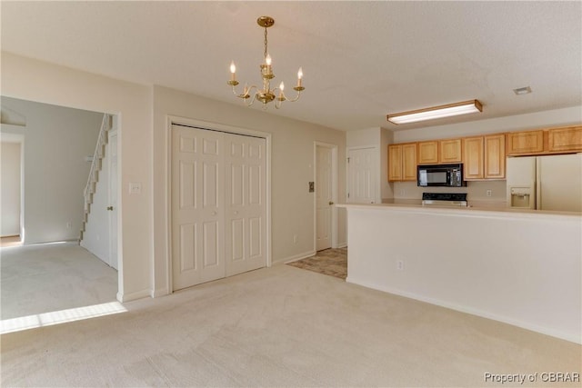 kitchen with black microwave, white fridge with ice dispenser, light carpet, a chandelier, and range