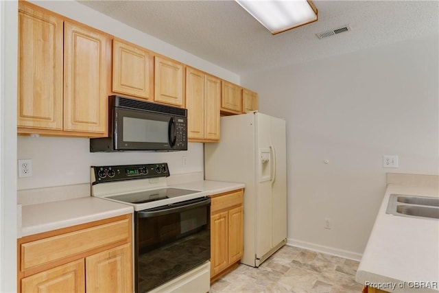 kitchen with range with electric stovetop, black microwave, light brown cabinets, white refrigerator with ice dispenser, and light countertops