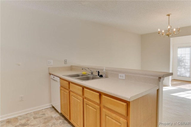 kitchen featuring a sink, dishwasher, a chandelier, a textured ceiling, and a peninsula