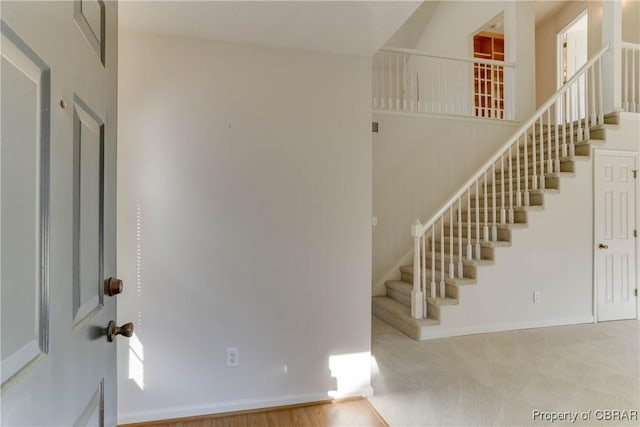 entryway with stairs and baseboards