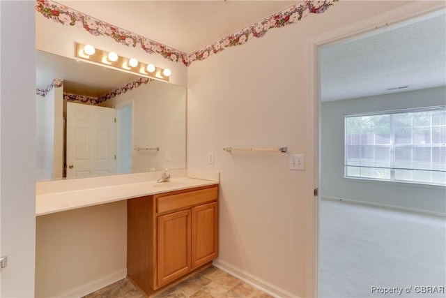bathroom with baseboards and vanity