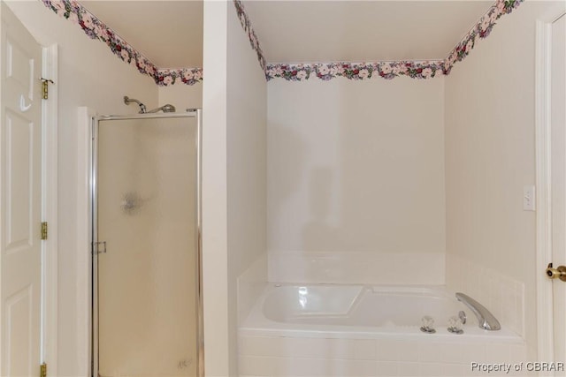 bathroom with a shower stall and a garden tub