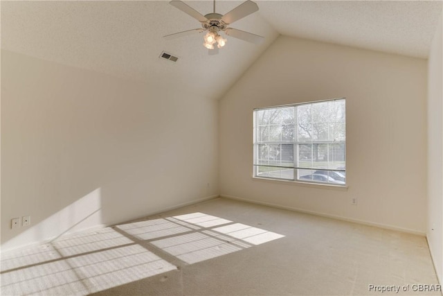carpeted empty room featuring vaulted ceiling and a ceiling fan