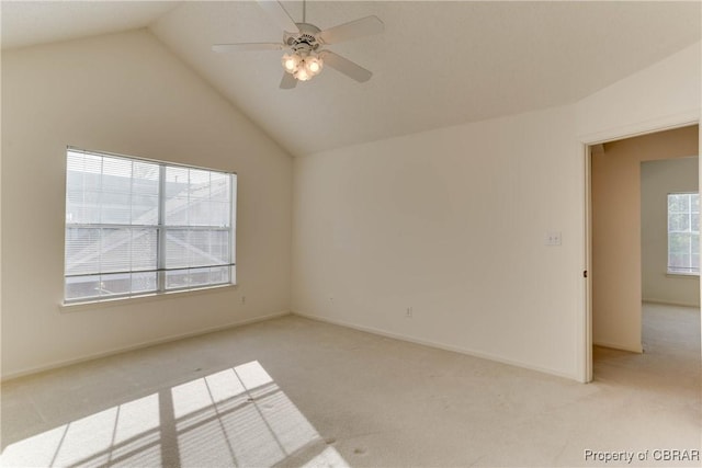 unfurnished room with light carpet, ceiling fan, lofted ceiling, and baseboards