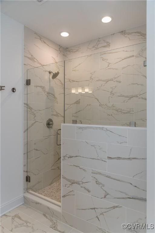 bathroom with a marble finish shower, marble look tiles, recessed lighting, and baseboards