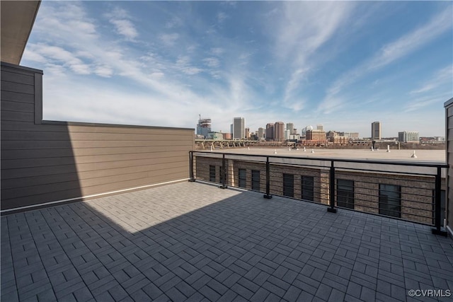 view of patio / terrace featuring a view of skyline and a balcony