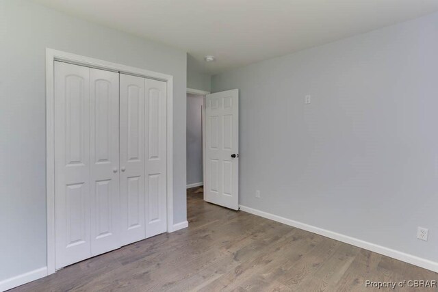 917 Chapel Neck Rd, North, VA 23128 - unfurnished bedroom with a closet, baseboards, and wood finished floors
