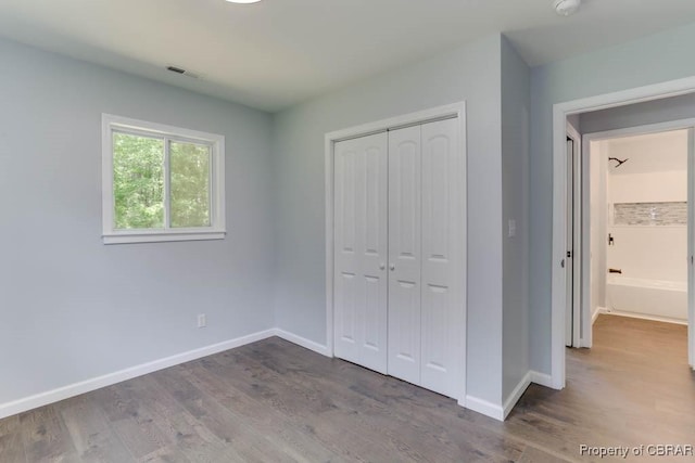 917 Chapel Neck Rd, North, VA 23128 - unfurnished bedroom featuring baseboards, a closet, and wood finished floors