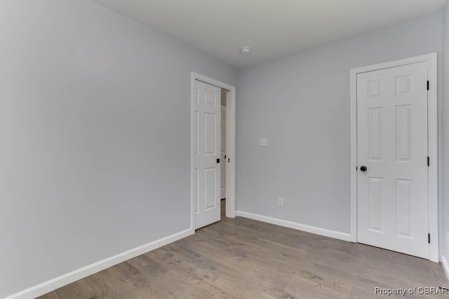 917 Chapel Neck Rd, North, VA 23128 - unfurnished bedroom with baseboards and wood finished floors