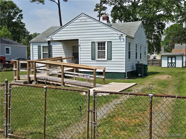 rear view of house with a chimney, a deck, roof with shingles, and a gate