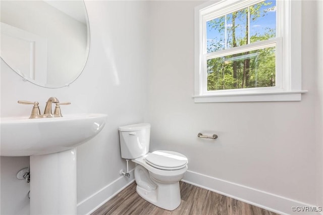 409 Confederate Dr, Orange, VA 22508 - half bath with baseboards, healthy amount of natural light, toilet, and wood finished floors