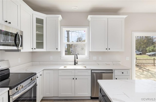 409 Confederate Dr, Orange, VA 22508 - kitchen featuring appliances with stainless steel finishes, a sink, white cabinetry, and light stone countertops