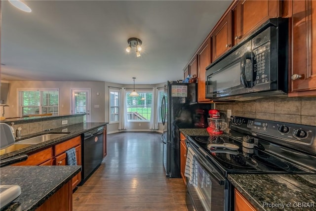 5631 Buckhunt Ln, New Kent, VA 23124 - kitchen with black appliances, brown cabinets, and decorative backsplash
