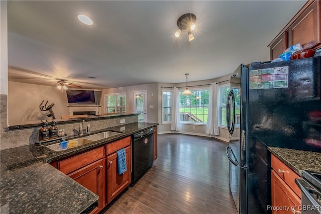 5631 Buckhunt Ln, New Kent, VA 23124 - kitchen featuring black appliances, a sink, open floor plan, brown cabinetry, and dark wood-style floors