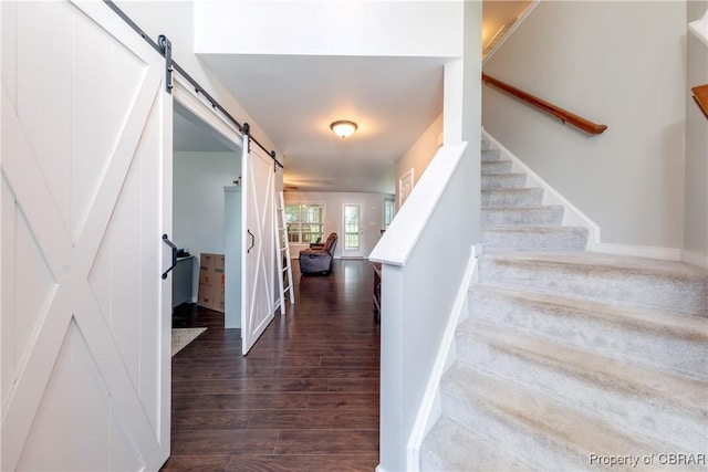 5631 Buckhunt Ln, New Kent, VA 23124 - stairway with a barn door, wood finished floors, and baseboards