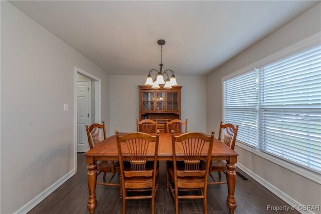 5631 Buckhunt Ln, New Kent, VA 23124 - dining space featuring a chandelier, dark wood-style flooring, and baseboards