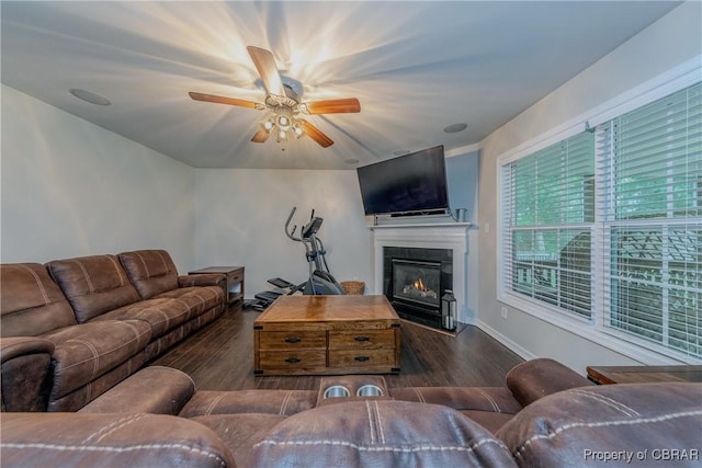 5631 Buckhunt Ln, New Kent, VA 23124 - living room featuring wood finished floors, ceiling fan, a glass covered fireplace, and baseboards