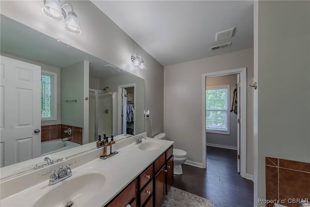 5631 Buckhunt Ln, New Kent, VA 23124 - bathroom with a shower stall, baseboards, double vanity, wood finished floors, and a garden tub