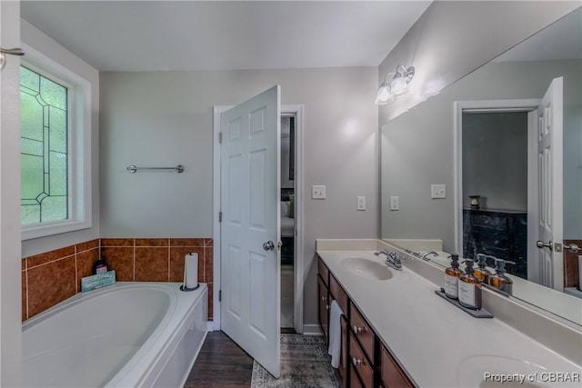 5631 Buckhunt Ln, New Kent, VA 23124 - bathroom with plenty of natural light, a garden tub, double vanity, and wood finished floors