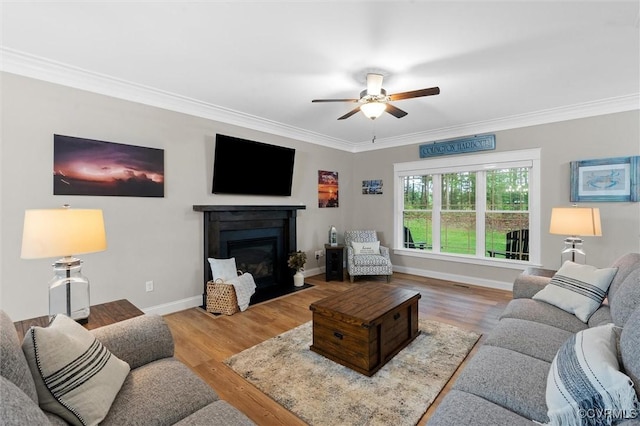 1270 Mill Quarter Rd, Powhatan, VA 23139 - living area with a ceiling fan, crown molding, a fireplace with flush hearth, wood finished floors, and baseboards