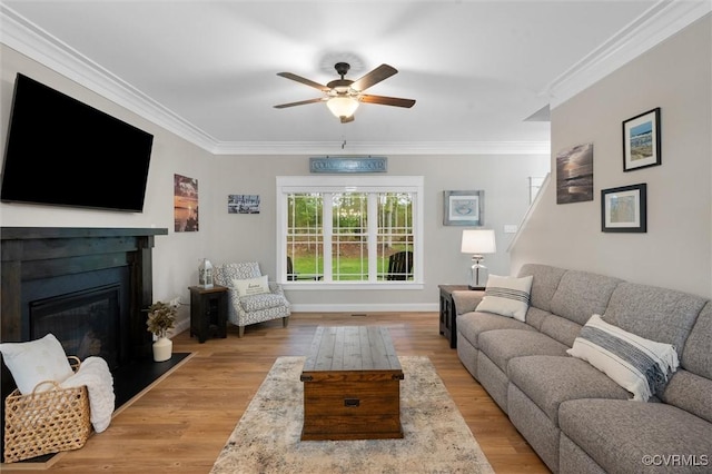 1270 Mill Quarter Rd, Powhatan, VA 23139 - living area featuring ceiling fan, crown molding, a glass covered fireplace, wood finished floors, and baseboards