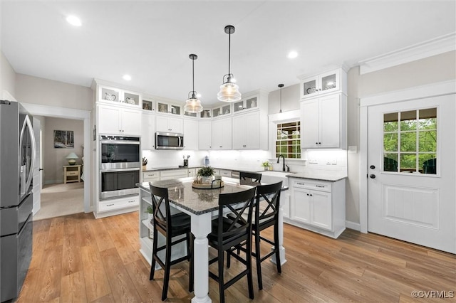 1270 Mill Quarter Rd, Powhatan, VA 23139 - kitchen featuring stainless steel appliances, a kitchen breakfast bar, white cabinetry, light wood-style flooring, and recessed lighting