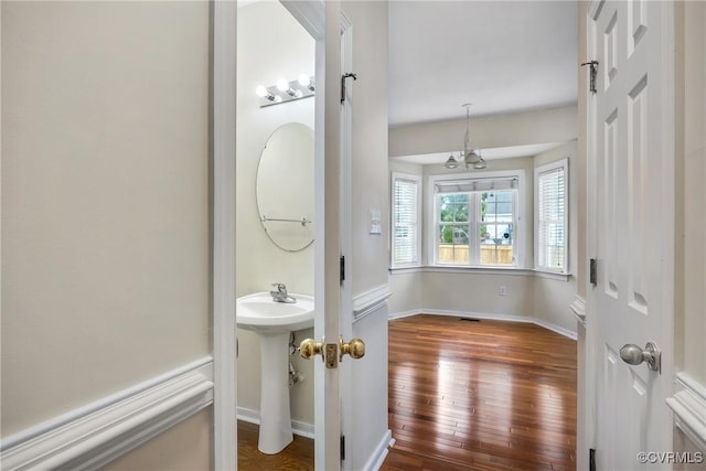 4221 Hunter Green Ct, Henrico, VA 23294 - bathroom featuring hardwood / wood-style flooring, a chandelier, baseboards, and a sink