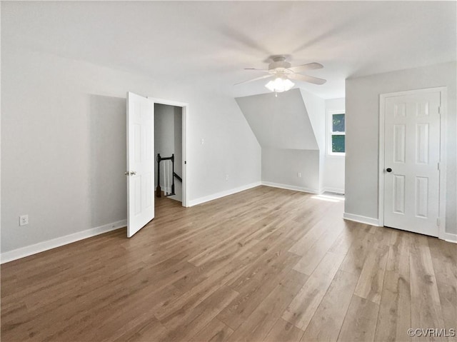 bonus room with ceiling fan, wood finished floors, and baseboards