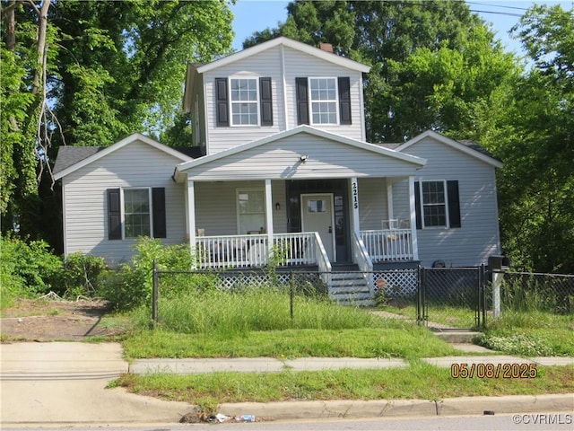 view of front of house featuring a porch and a fenced front yard