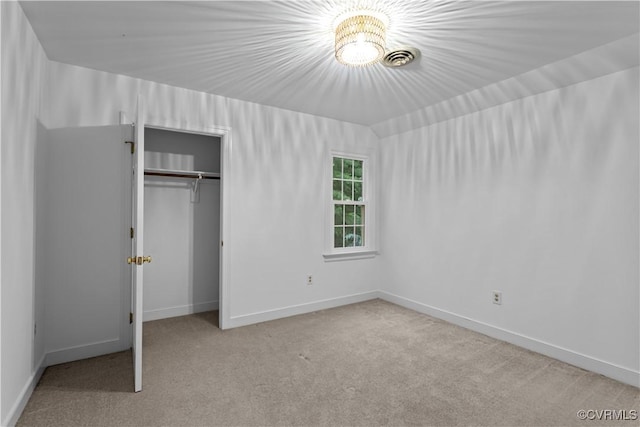 unfurnished bedroom with carpet floors, a closet, and baseboards