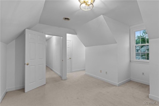 additional living space with carpet, lofted ceiling, and baseboards