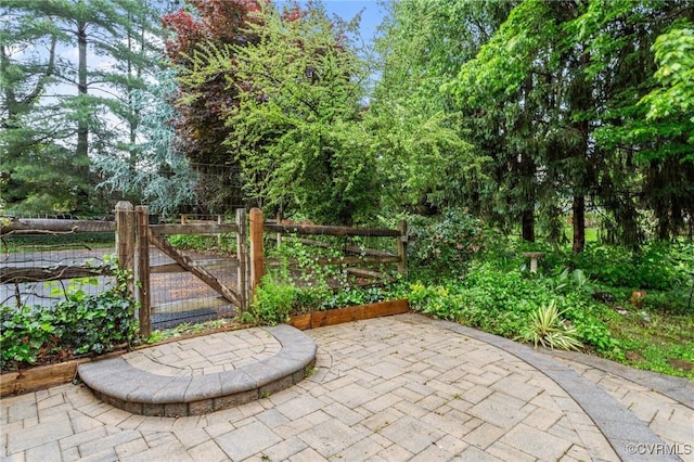 gate featuring fence and a patio area