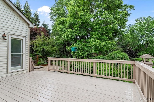 deck featuring view of wooded area