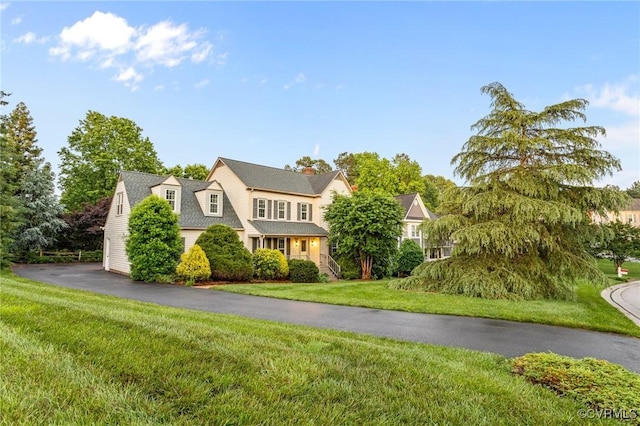 view of front of home featuring a front lawn and a chimney